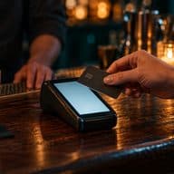 A card being tapped on a terminal at the bar